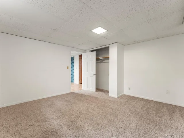 a view of an empty room and a window