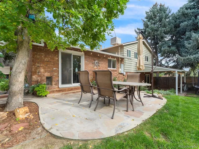 a view of a house with a yard patio and sitting area