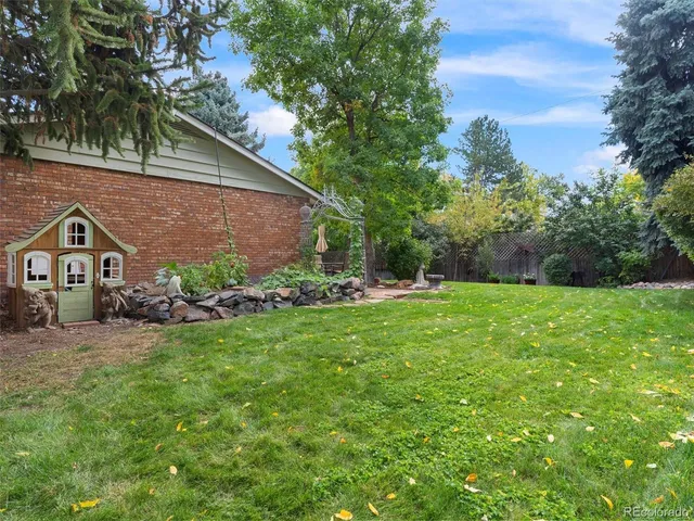 a view of a house with a yard and sitting area