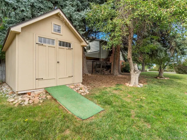 a view of an house with backyard space and garden