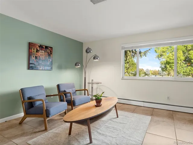 a view of a livingroom with furniture and a window