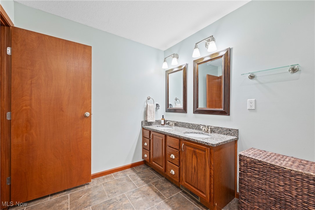 399 Wilder Road Vinton, OH 45686 - Photo 16 of 36 Bathroom featuring double vanity and baseboards