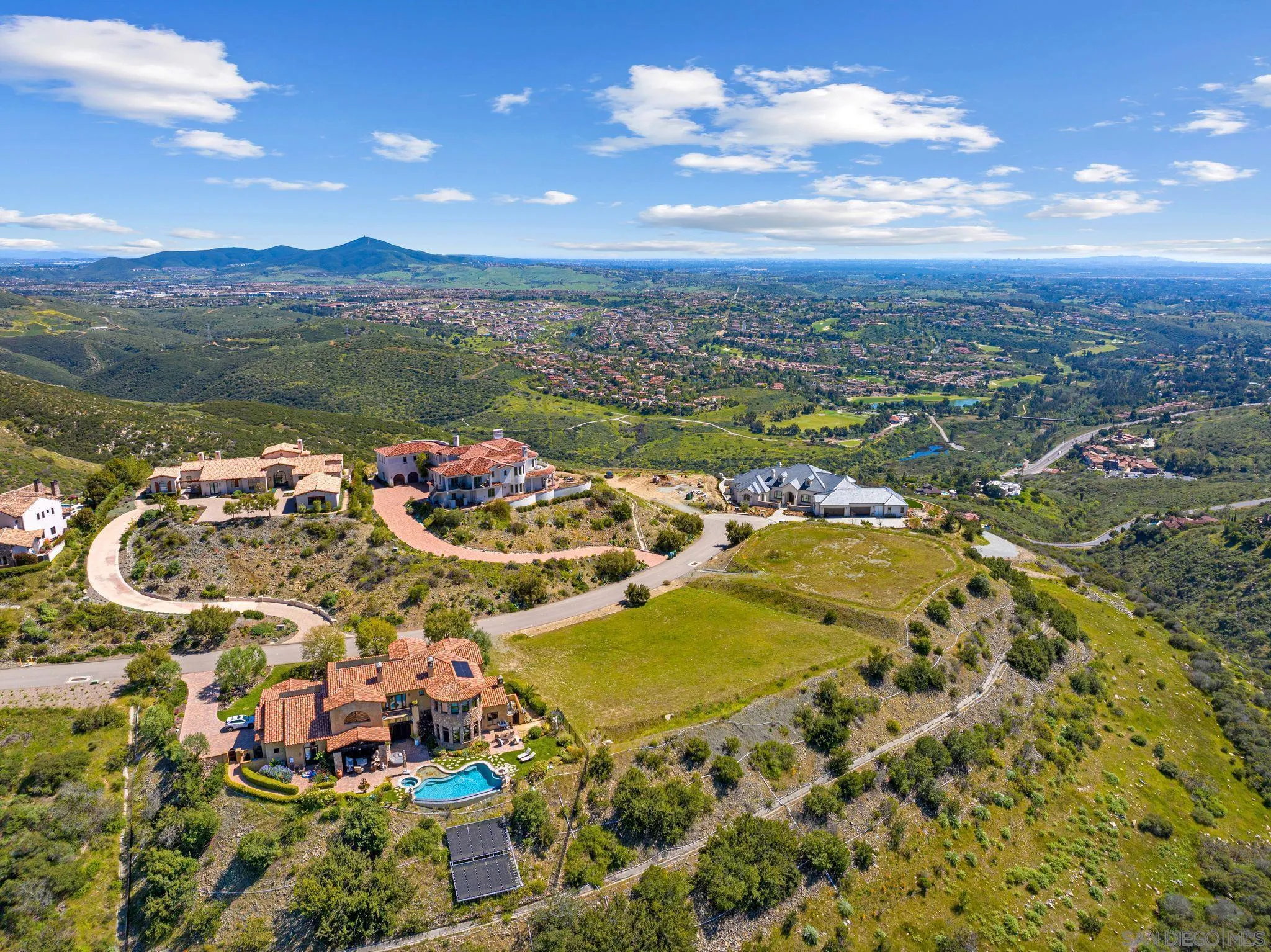 an aerial view of residential houses with outdoor space