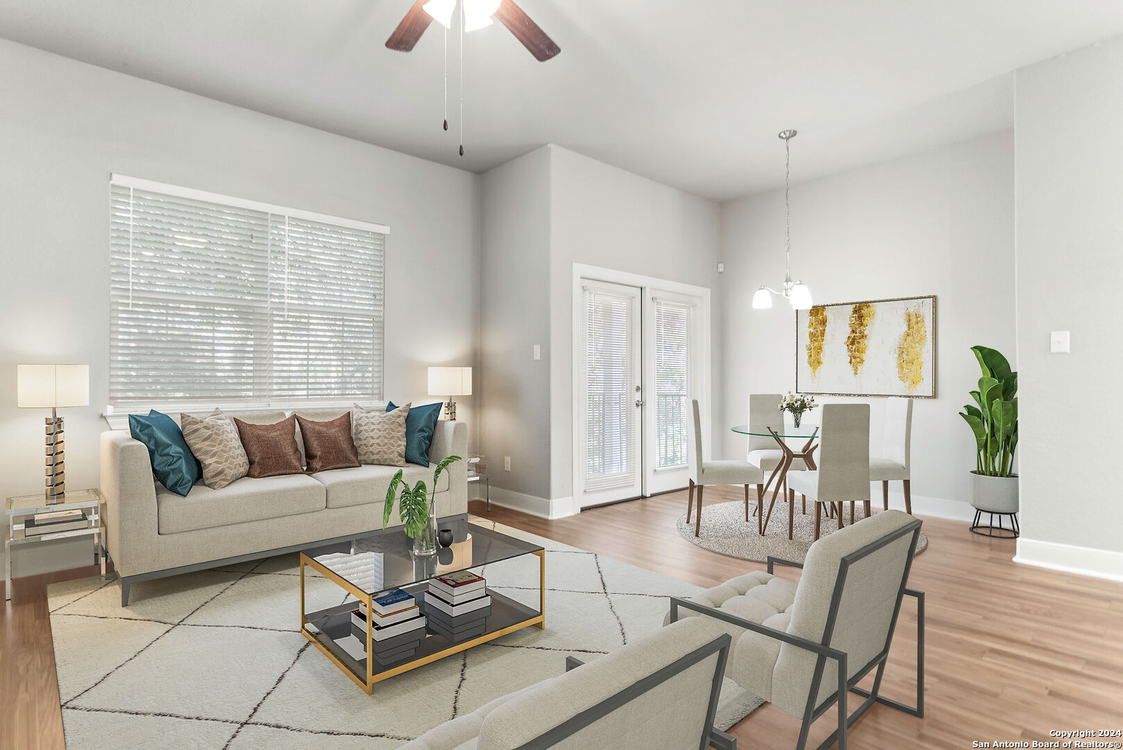 a living room with furniture a dining table and a window