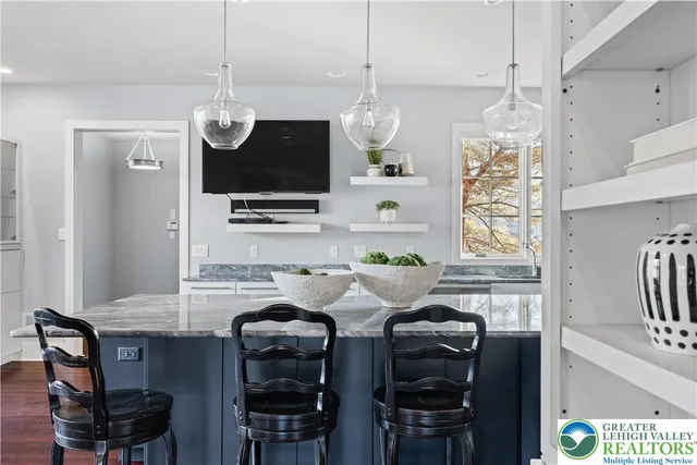 a large room with a lot of white furniture