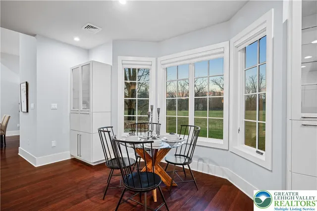 a view of a room with wooden floor and windows