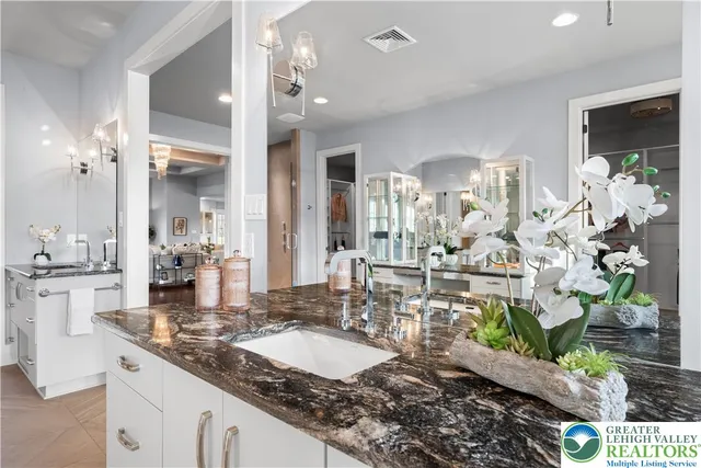a bathroom with a sink and mirror