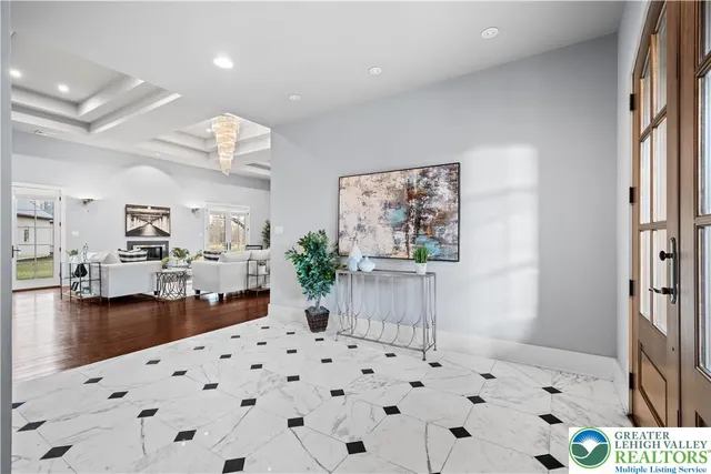 a open kitchen with stainless steel appliances granite countertop a stove top oven a refrigerator a dining table and chairs with wooden floor