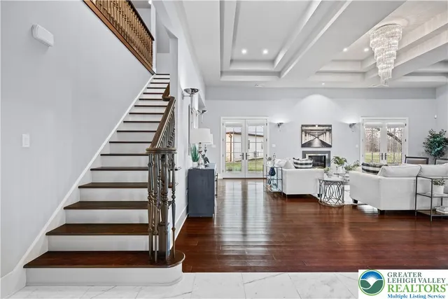 a large white kitchen with lots of counter space wooden floor and appliances