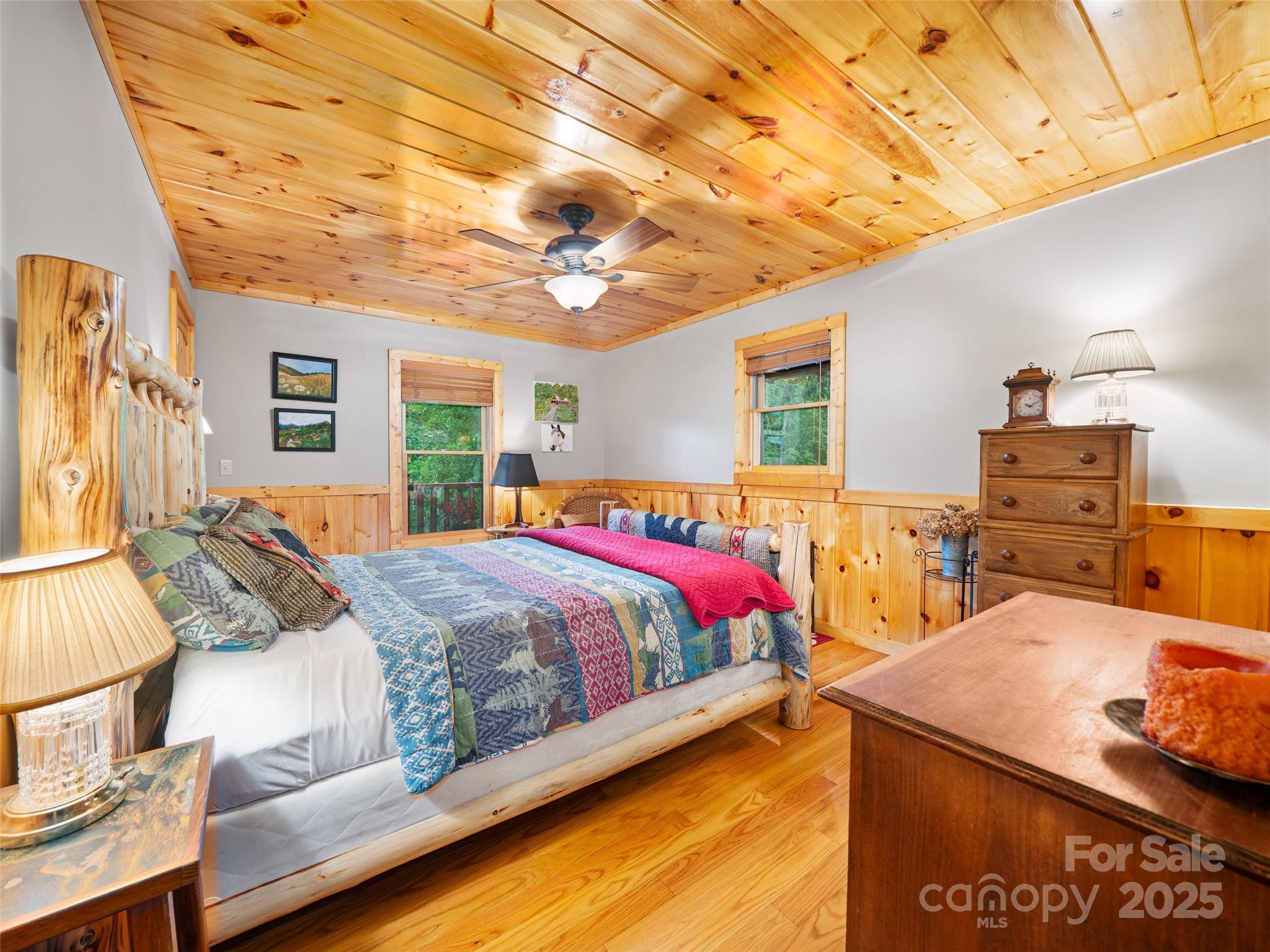 198 Grace Ridge Road Bakersville, NC 28705 - Photo 13 of 27 a spacious bedroom with a bed and wooden cabinets
