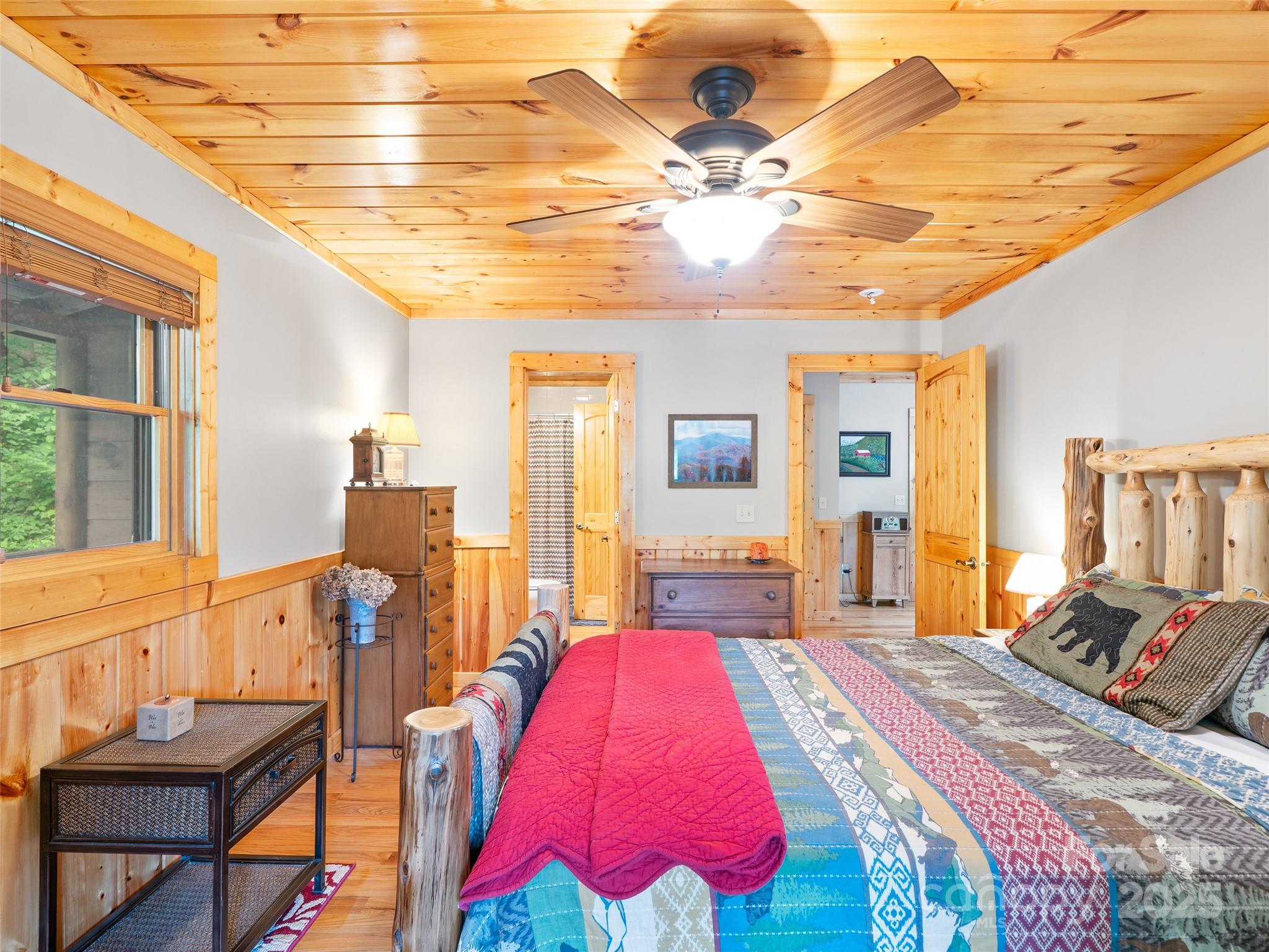 198 Grace Ridge Road Bakersville, NC 28705 - Photo 14 of 27 a bed room with a bed and a chandelier