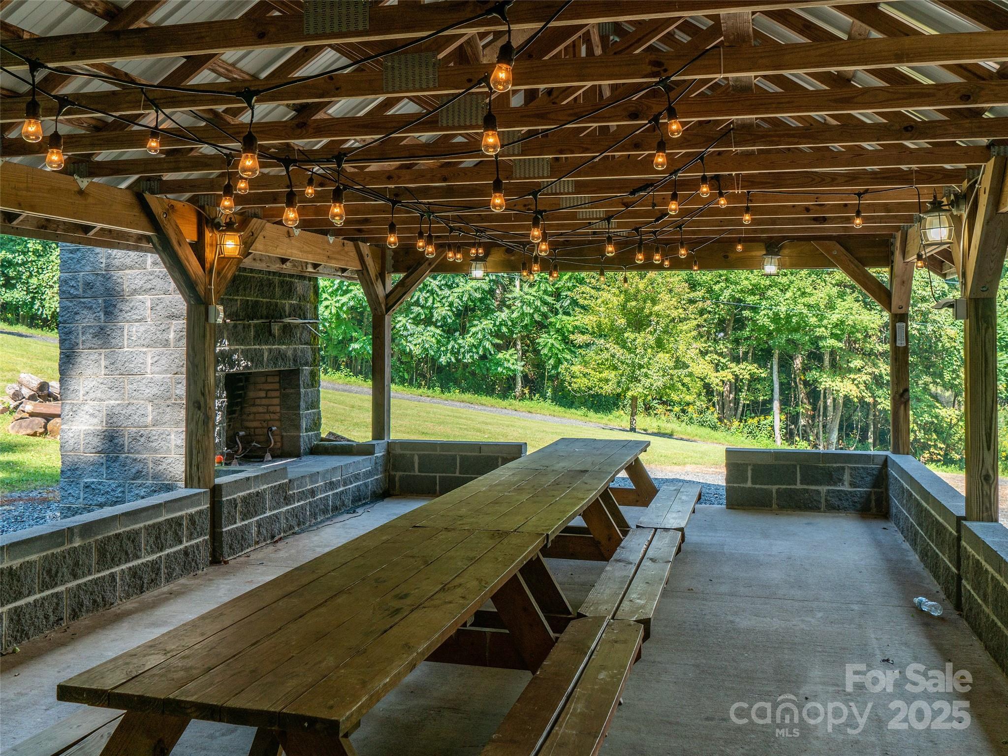198 Grace Ridge Road Bakersville, NC 28705 - Photo 27 of 27 a view of a patio with table and chairs a barbeque with wooden floor and roof
