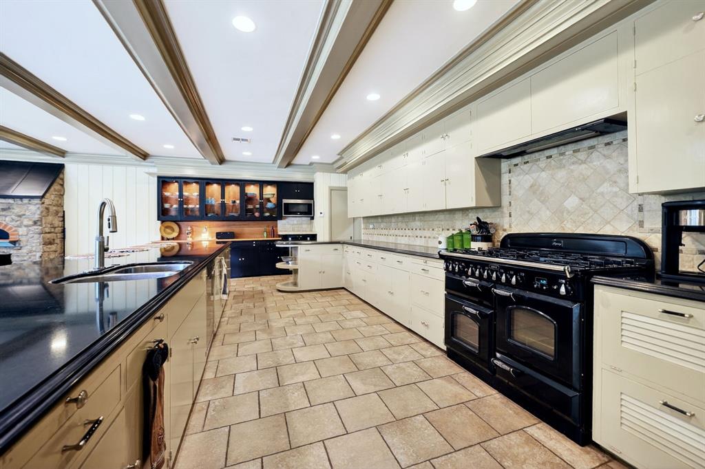 1901 Rose Pointe Athens, TX 75752 - Photo 12 of 37 Spacious kitchen featuring a large black range, extensive cabinetry, recessed lighting, and a stone pizza oven