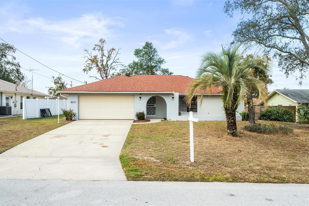 2027 Beckwith Avenue Spring Hill, FL 34608 - Photo 1 of 1 a front view of a house with garden