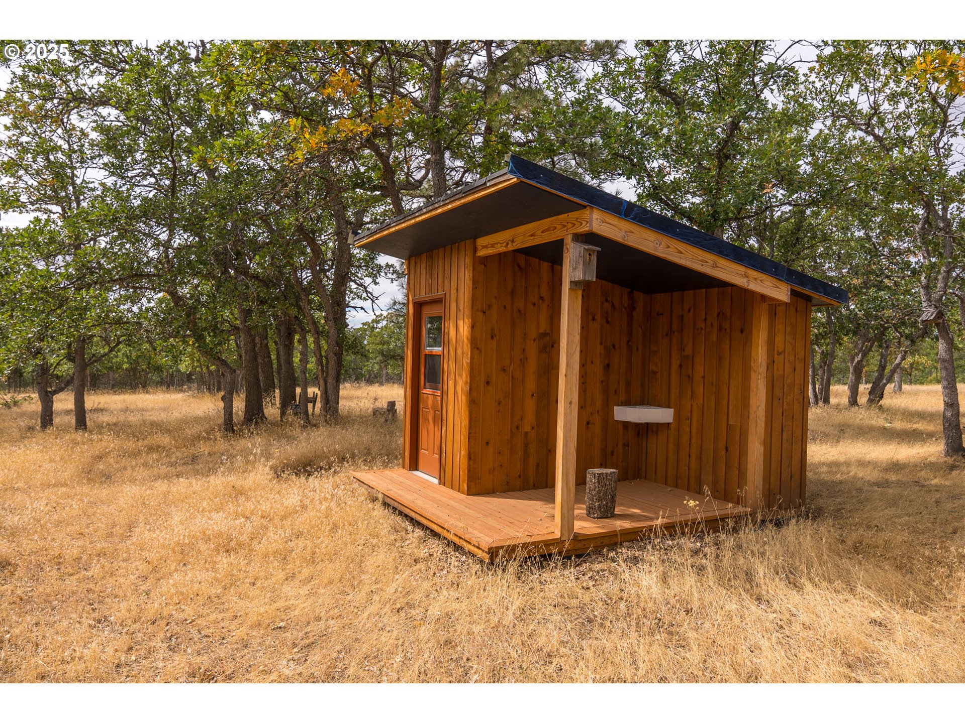 76 Big Springs Road Goldendale, WA 98620 - Photo 24 of 48 a wooden house with trees in the background