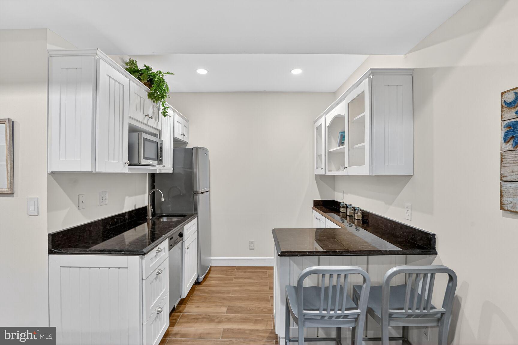 4837 W Street Northwest Washington, DC 20007 - Photo 47 of 59 Kitchenette with dishwasher, sink and microwave
