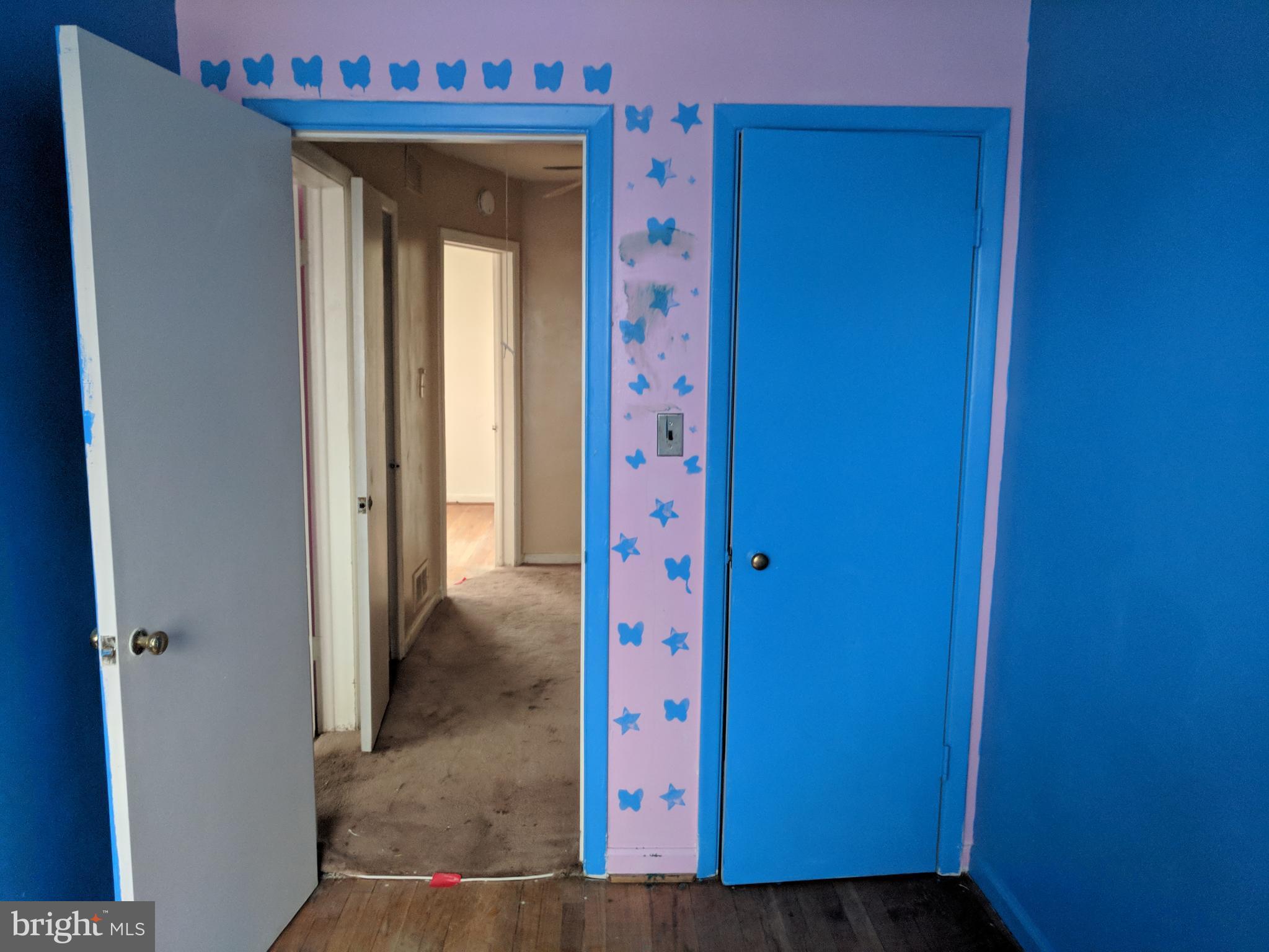 4452 Scotia Road Baltimore, MD 21227 - Photo 18 of 20 a view of a hallway with wooden walls