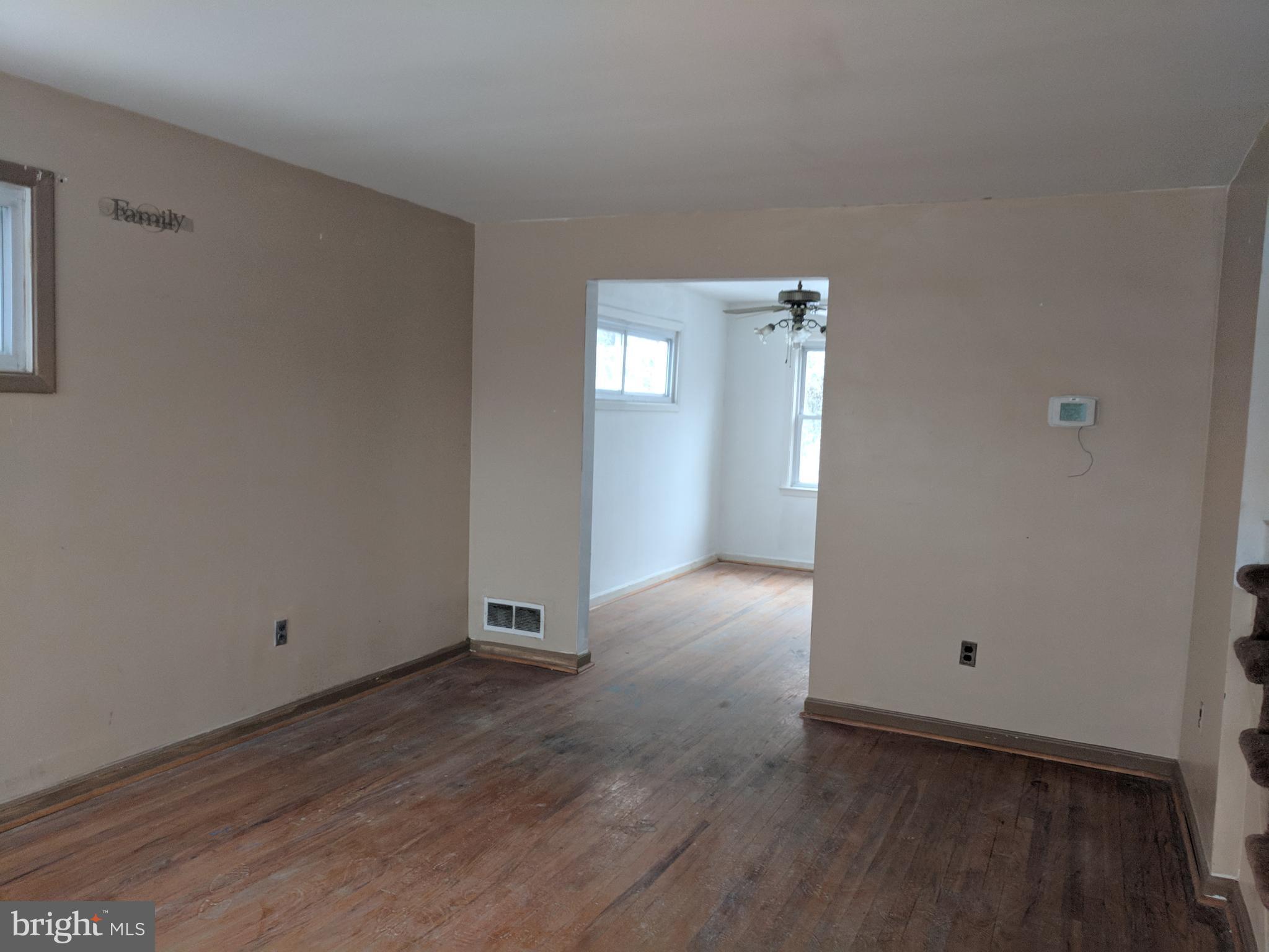 4452 Scotia Road Baltimore, MD 21227 - Photo 5 of 20 a view of an empty room with wooden floor and closet