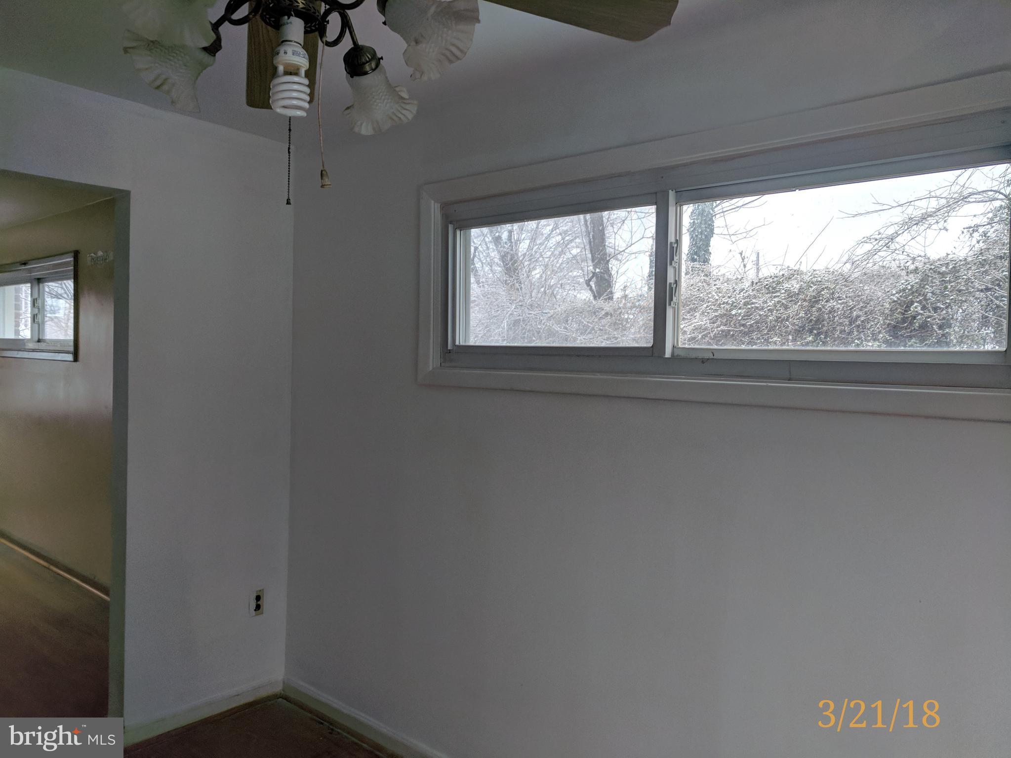 4452 Scotia Road Baltimore, MD 21227 - Photo 8 of 20 a view of empty room with wooden floor and fan