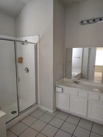 a bathroom with a sink a mirror and shower