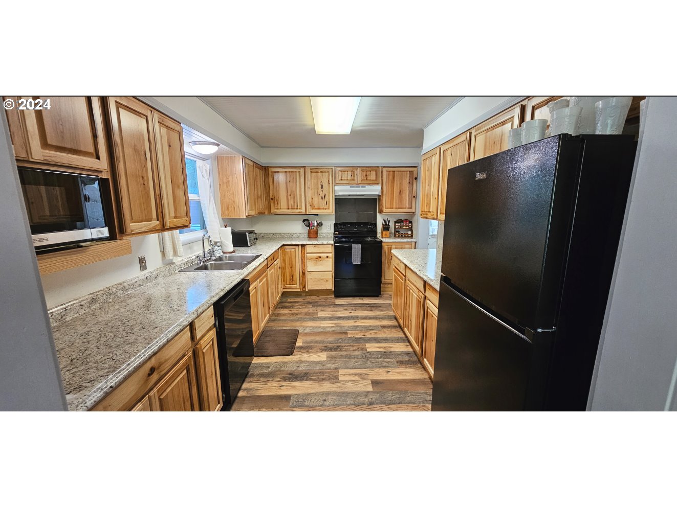 11354 Highway 36 Mapleton, OR 97453 - Photo 7 of 15 a kitchen with stainless steel appliances granite countertop a refrigerator a stove and a sink with wooden cabinets