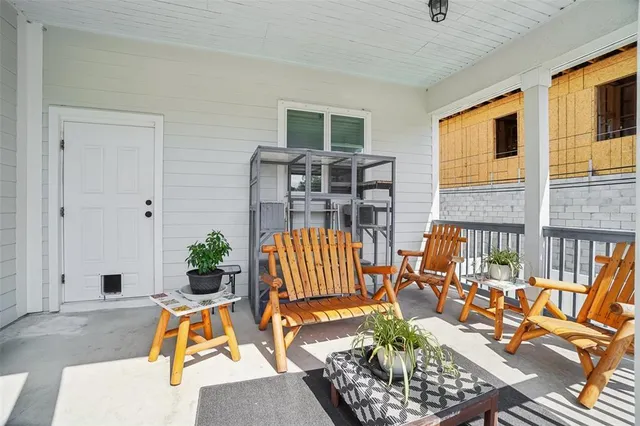 a wooden bench sitting in front of a house