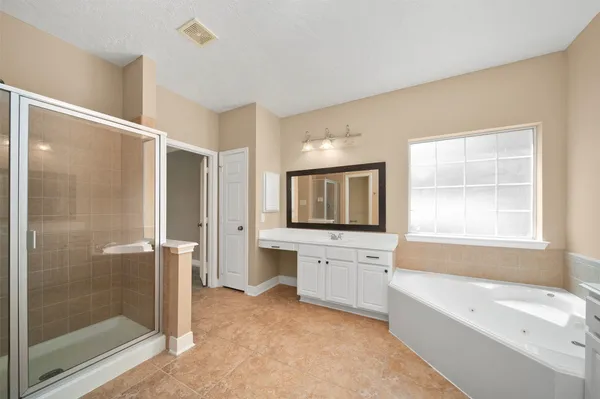 a bathroom with a bathtub shower and a sink