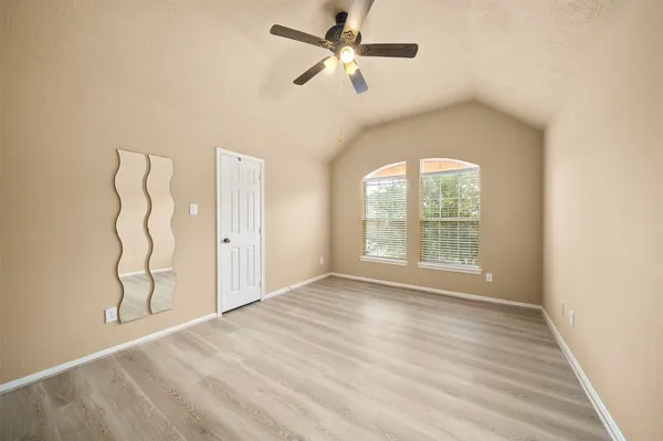a view of a livingroom with a ceiling fan and window