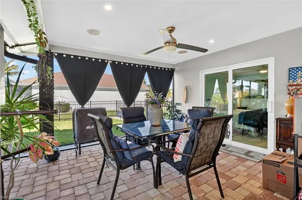 a view of a dining room with furniture and front door