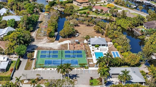 an aerial view of a house with swimming pool and outdoor seating