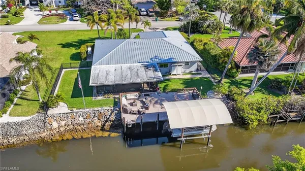 an aerial view of a house with swimming pool outdoor seating and yard