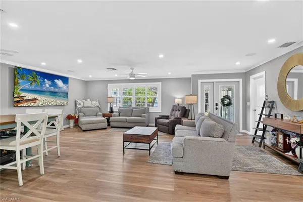 a living room with furniture and wooden floor