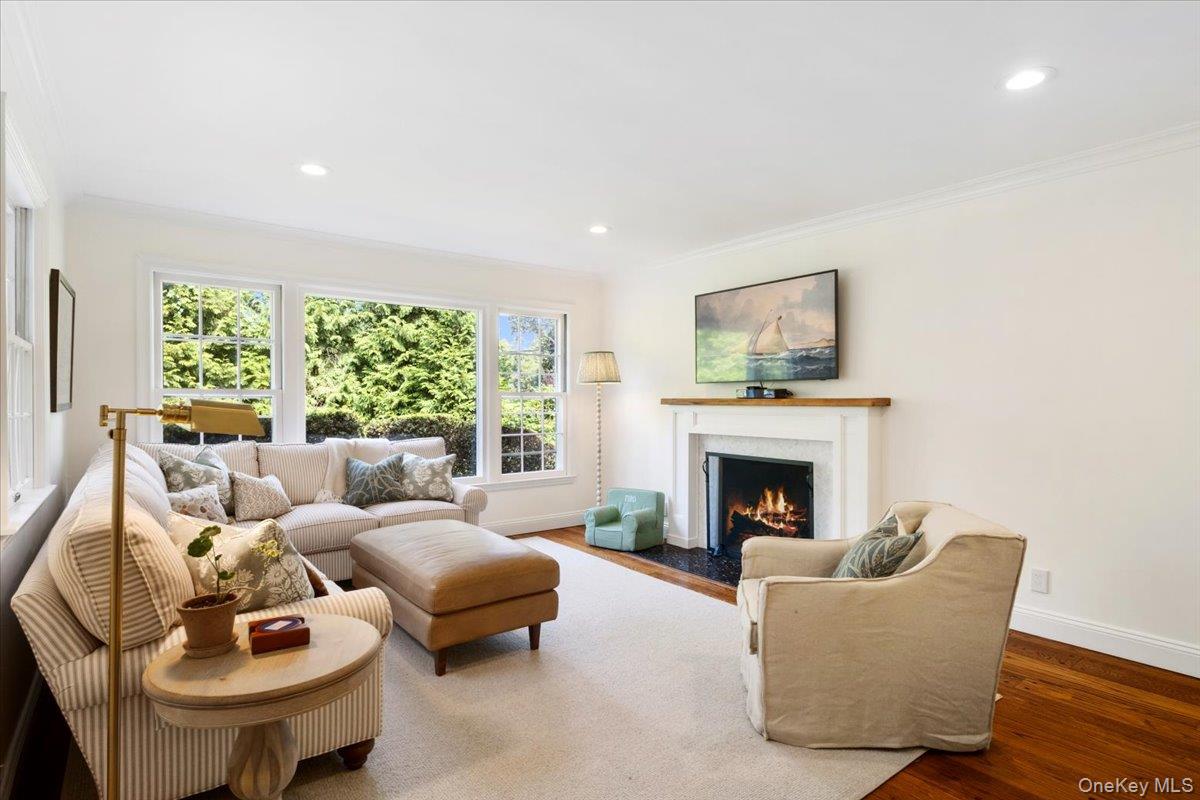 911 Cove Road Mamaroneck, NY 10543 - Photo 15 of 37 Family Room with wood burning fireplace, custom built in desk and cabinetry