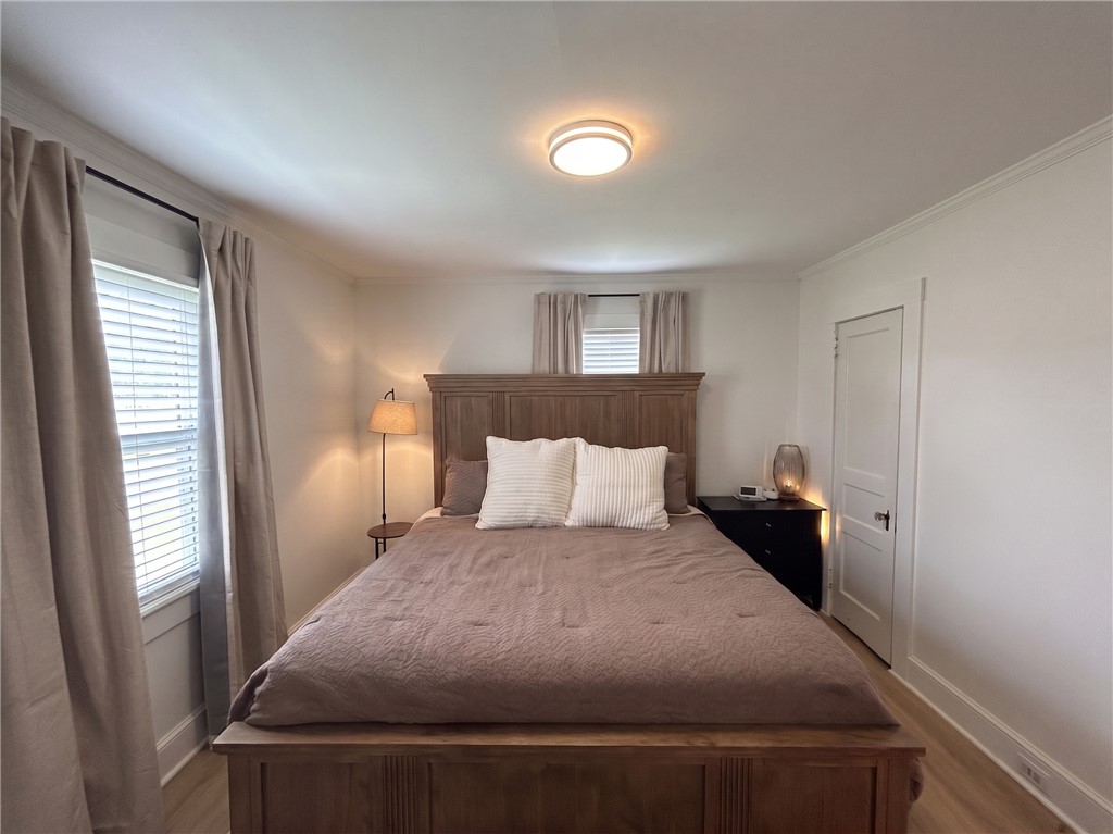710 O Neal Street Belton, SC 29627 - Photo 13 of 18 A well-appointed sleeping sanctuary awaits, featuring warm wood flooring and elegant crown molding.