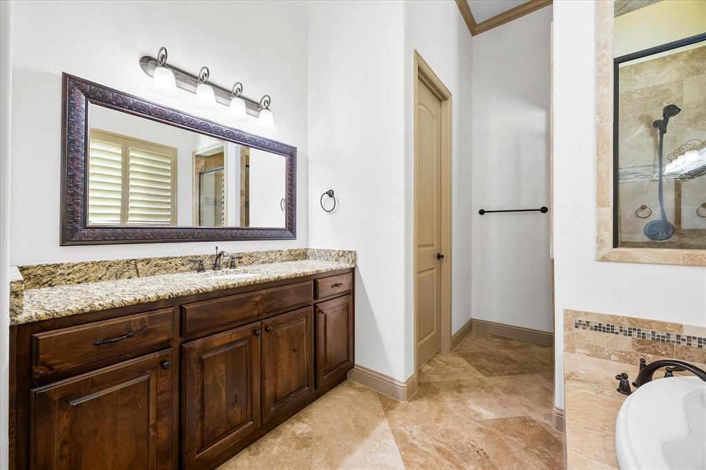 6814 Springwood Lane Garland, TX 75044 - Photo 24 of 35 a bathroom with a granite countertop sink and a mirror