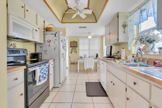 a kitchen with stainless steel appliances granite countertop a refrigerator and a stove