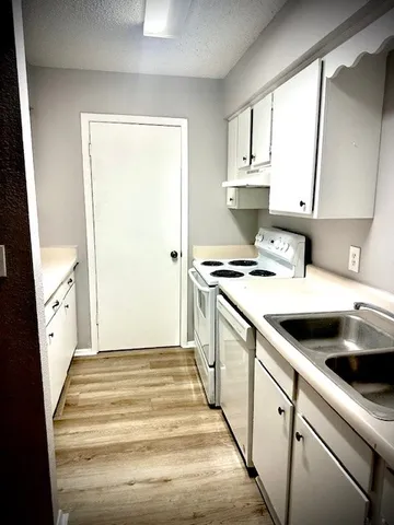 a kitchen with kitchen island a stove a sink and a refrigerator