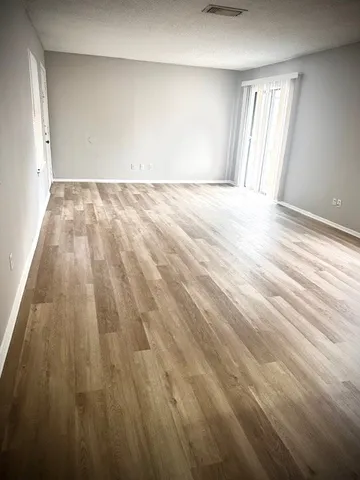 a view of an empty room and wooden floor