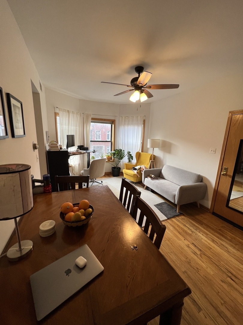 626 West Patterson Avenue, Unit 2E Chicago, IL 60613 - Photo 3 of 9 a living room with furniture and a chandelier
