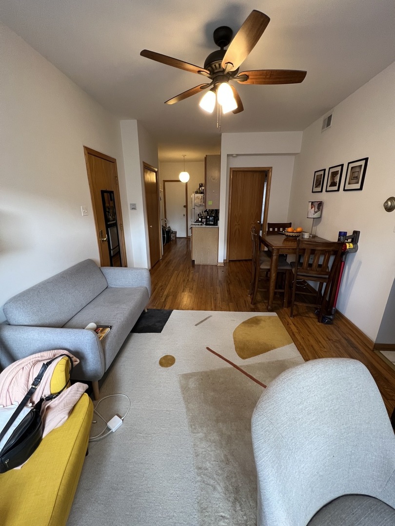 626 West Patterson Avenue, Unit 2E Chicago, IL 60613 - Photo 4 of 9 a living room with furniture and wooden floor