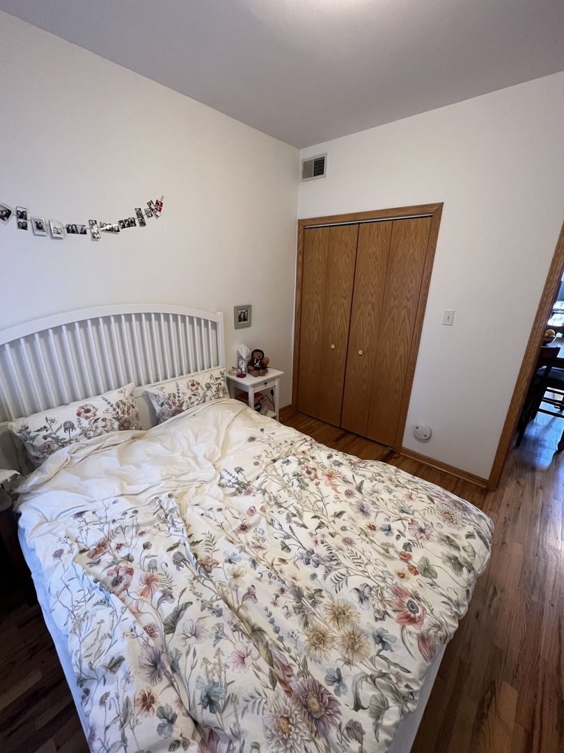 626 West Patterson Avenue, Unit 2E Chicago, IL 60613 - Photo 7 of 9 a bedroom with a bed and wooden floor