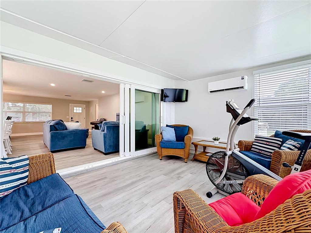 508 Shore Drive Largo, FL 33771 - Photo 12 of 31 a living room with furniture gym equipment and wooden floor