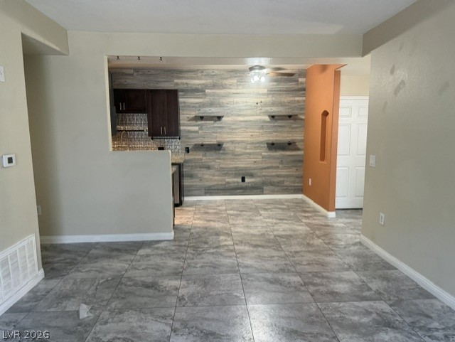 3318 North Decatur Boulevard, Unit 1163 Las Vegas, NV 89130 - Photo 8 of 35 Clean lines and wood-paneled accents define this contemporary interior, boasting durable tile flooring.