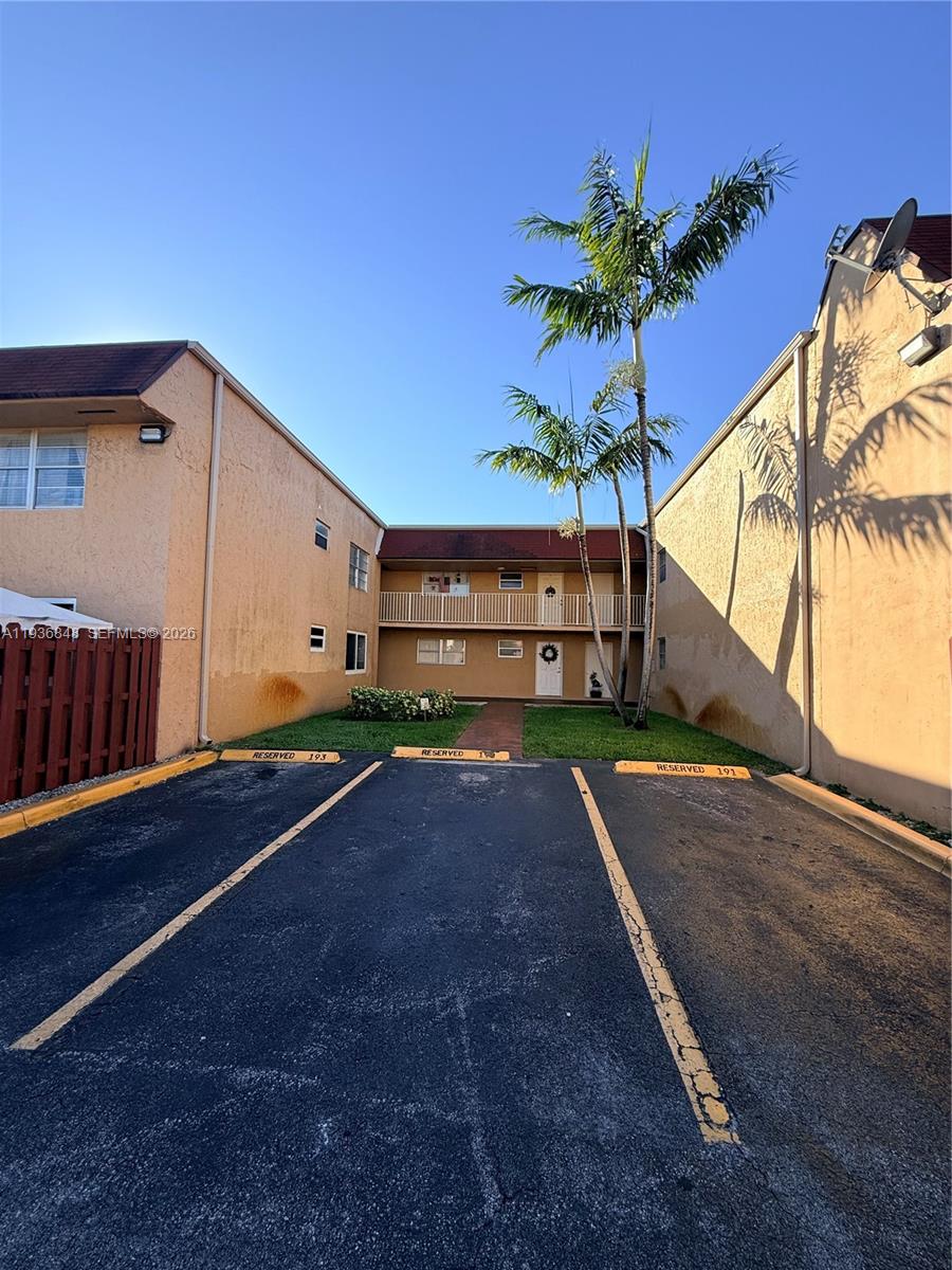 9972 Southwest 88th Street, Unit 1125 Miami, FL 33176 - Photo 2 of 18 a house with a yard and a wooden fence