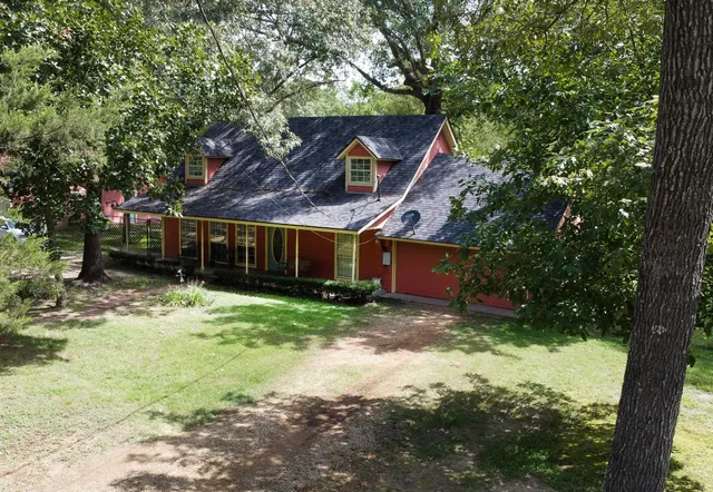 a backyard of a house with barbeque oven table and chairs