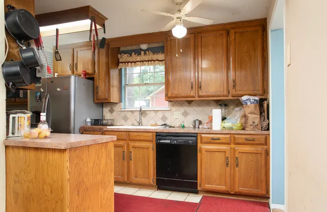 a kitchen with refrigerator and cabinets