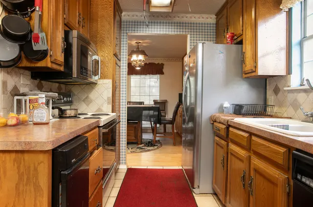a kitchen with stainless steel appliances granite countertop a sink and cabinets