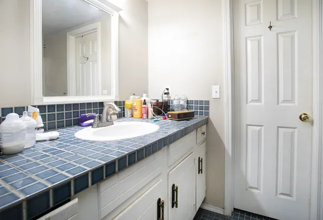 a bedroom with a bed and a mirror