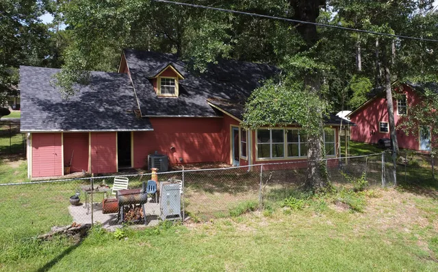 a view of backyard of house with green space