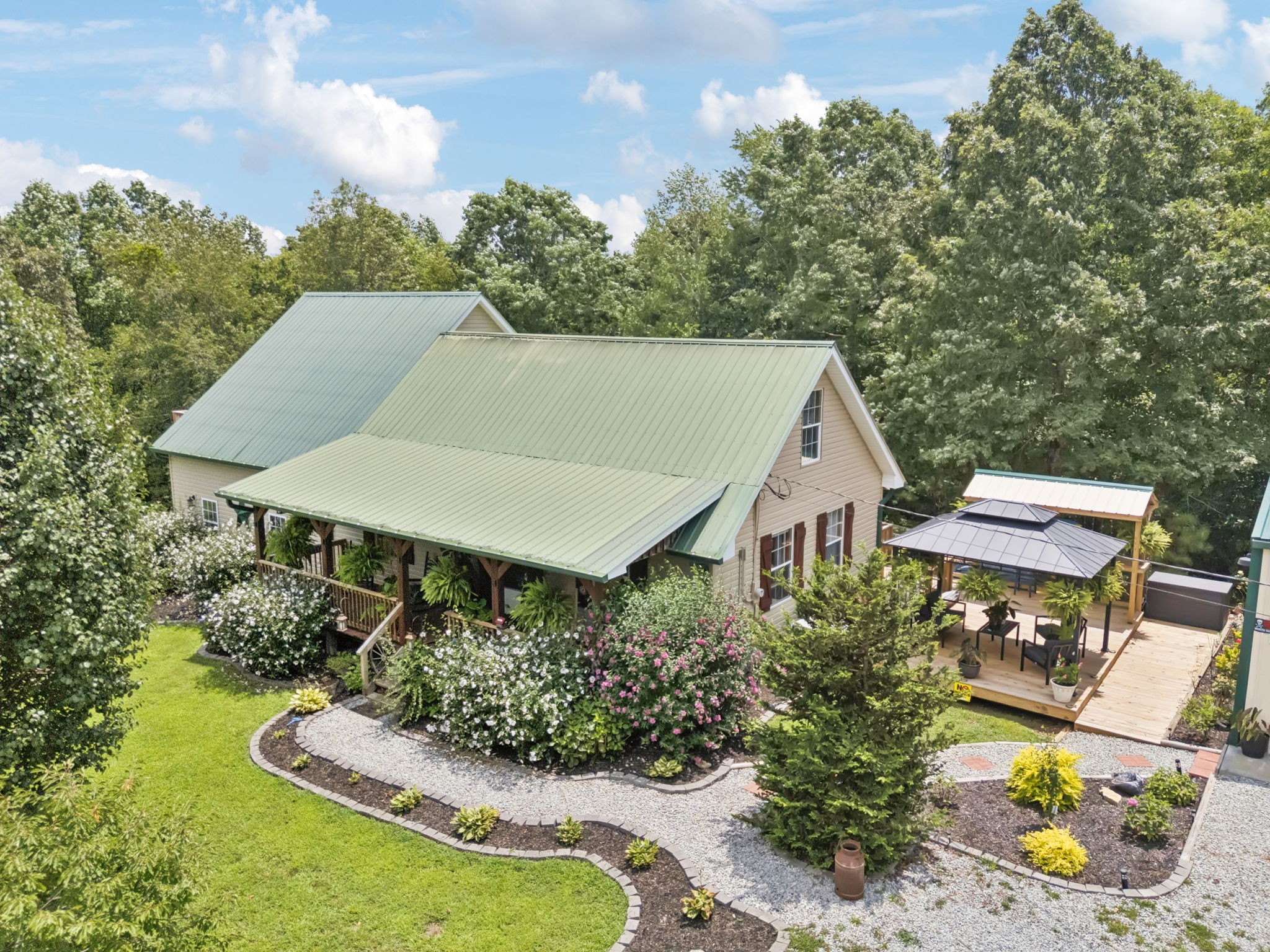 a aerial view of a house with table and chairs under an umbrella